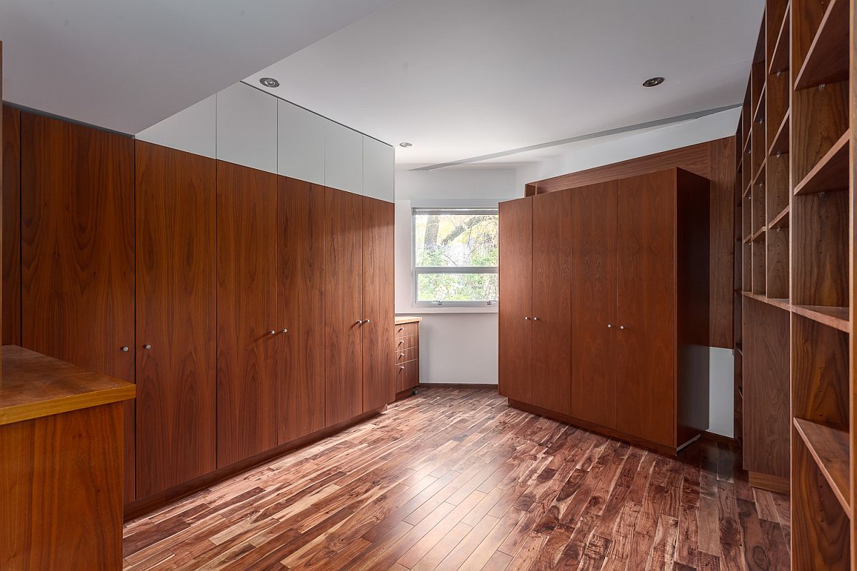 Custom wooden cabinetry provides amples space inside the industrial loft