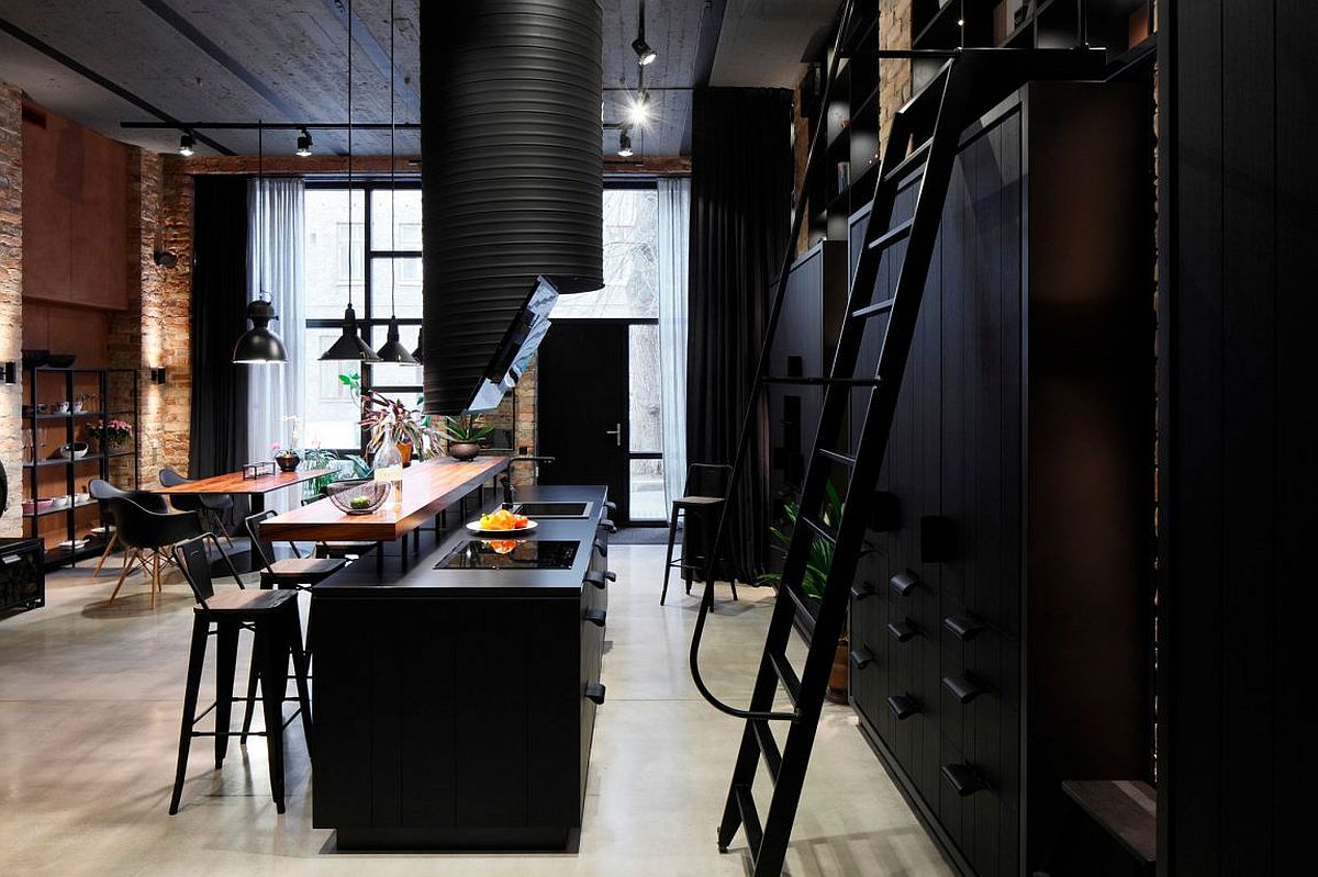 Dark kitchen in black with wooden breakfast counter