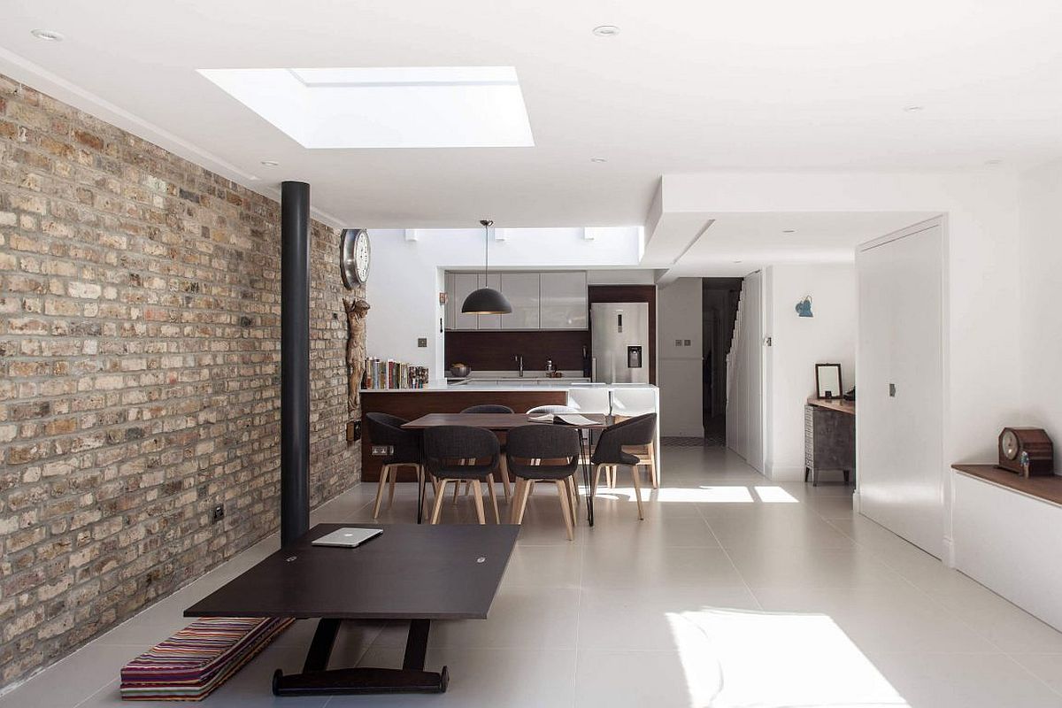 Exposed brick wall adds character and uniqueness to the white interior