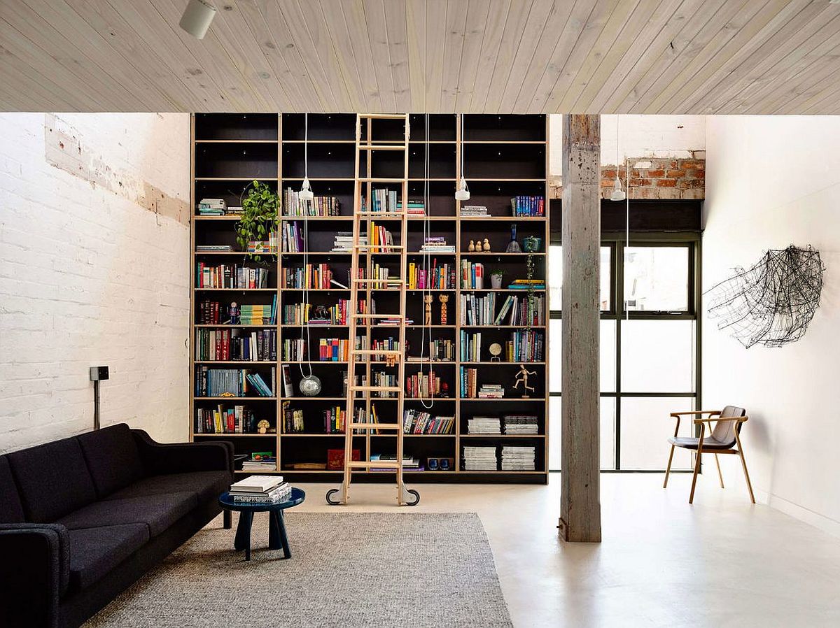 Floor-to-ceiling bookshelf adds both color and contrast to the loft home