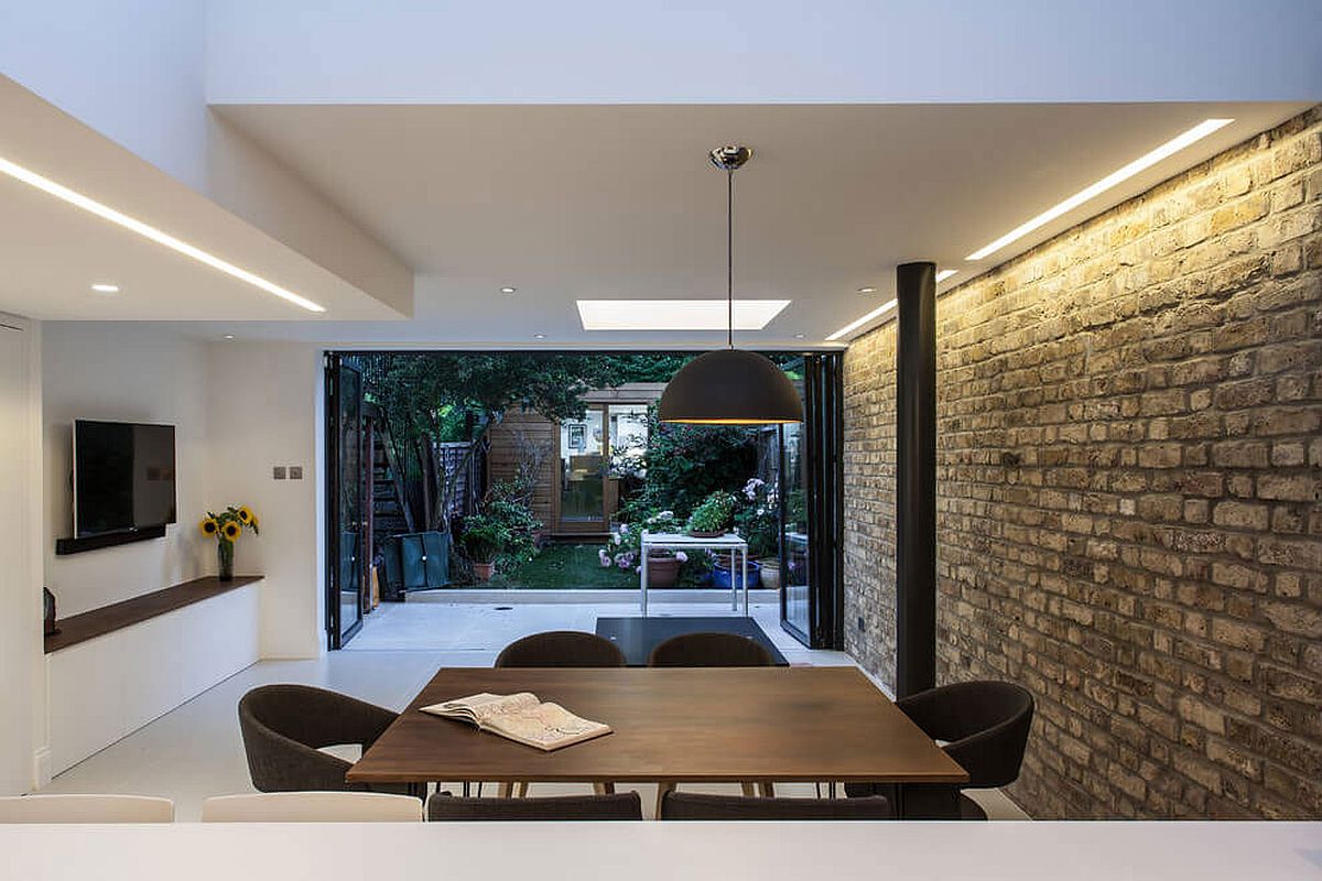 Folding glass doors connect the extension with the garden