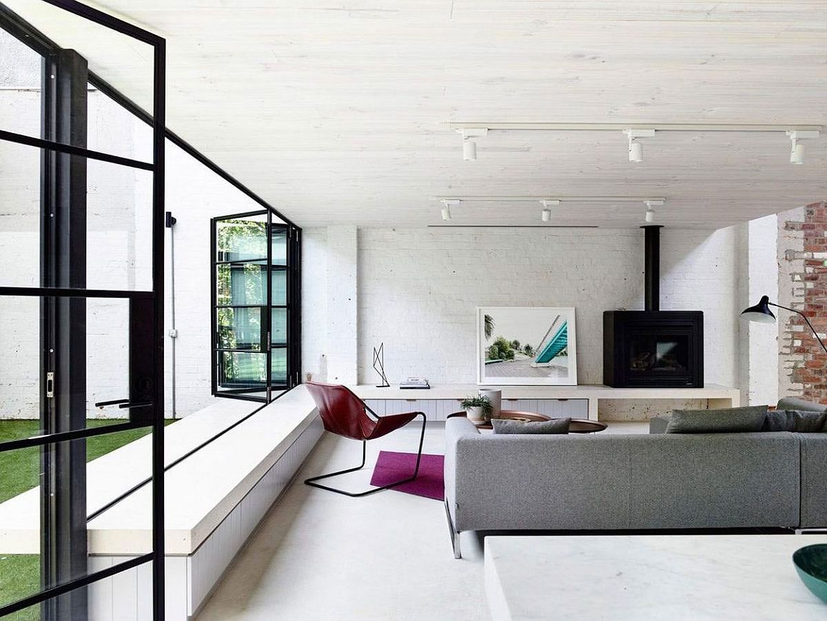 Folding industrial style windows and brick walls for the snazzy loft living room