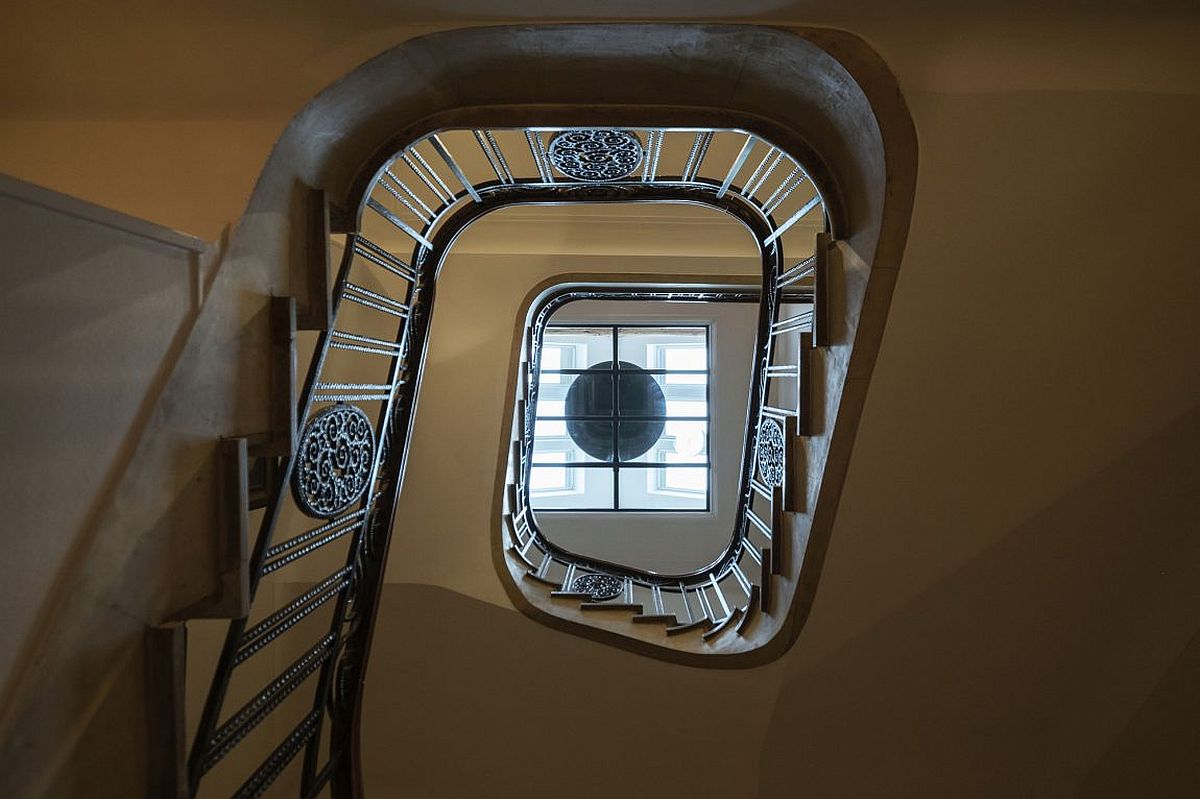 Gorgeous modern wood and steel staircase with light shaft brings in natural light to various levels of the house