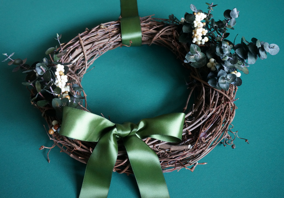 Holiday wreath with a green ribbon