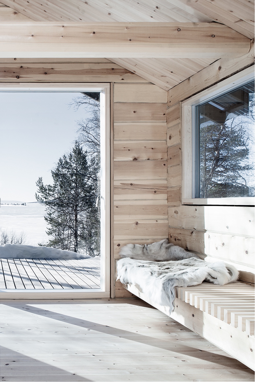 A cosy corner in Hytte Femunden, a cabin designed by Norwegian architect Aslak Haanshuus. Photo by Tom Gustavsen via Aslak Haanshuus Arkitekter.