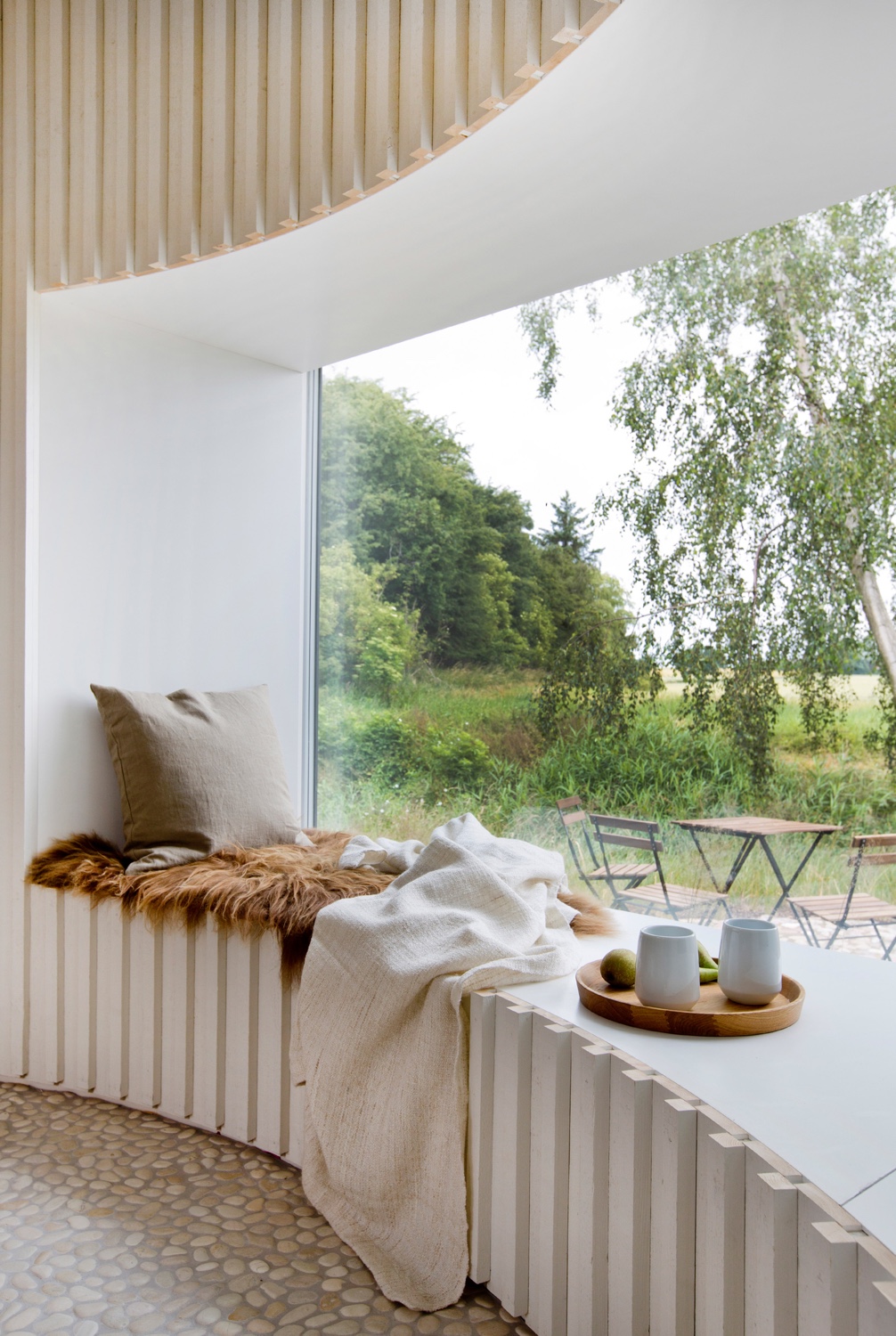 A cosy corner in a Danish holiday home designed by Copenhagen-based architect Jan Henrik Jansen. Photo by Lene K Fotografi via Dezeen.