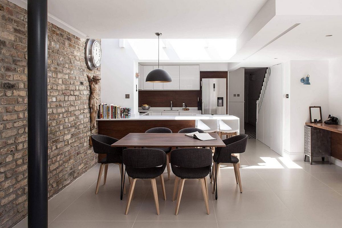 Large pendant above the kitchen counter gives the living area an industrial vibe