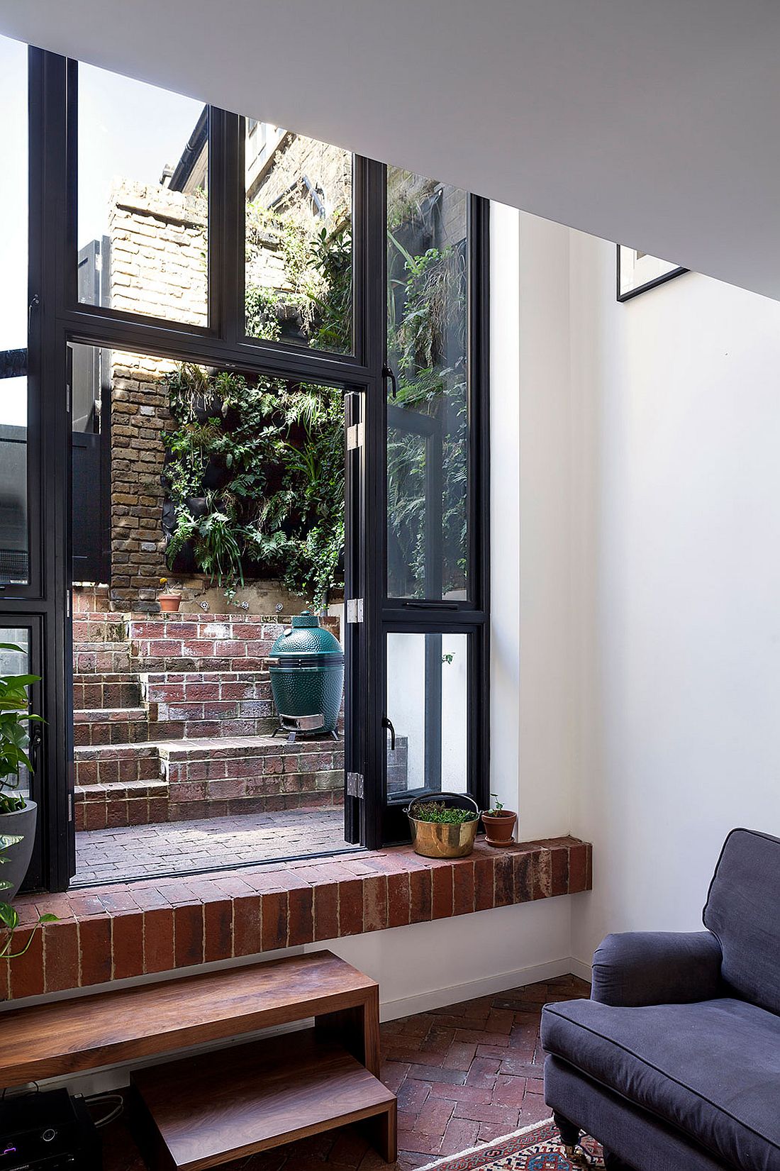 Living room leads into the private rear courtyard of the london home