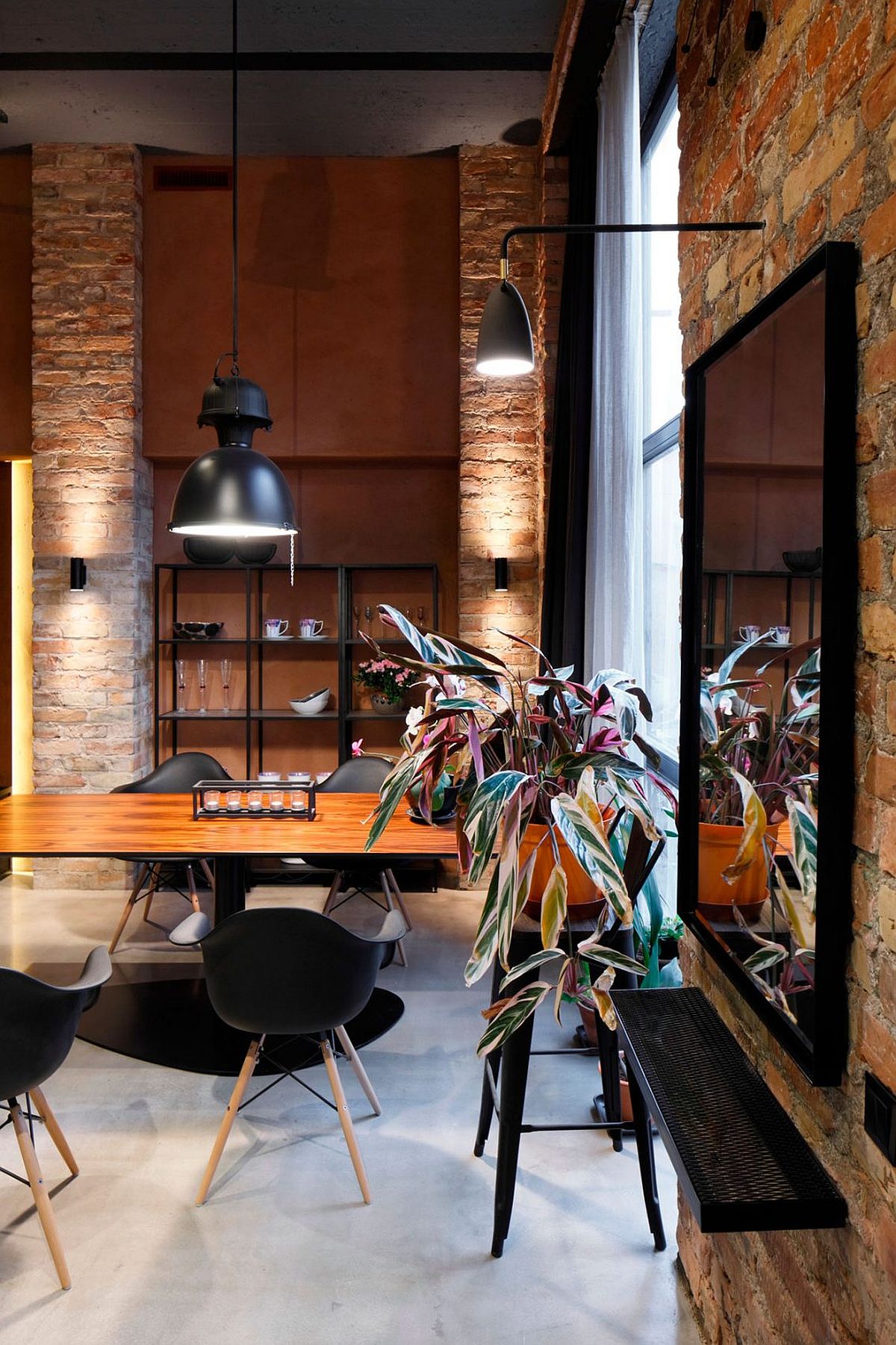 Modern industrial dining room with open shelves in the backdrop