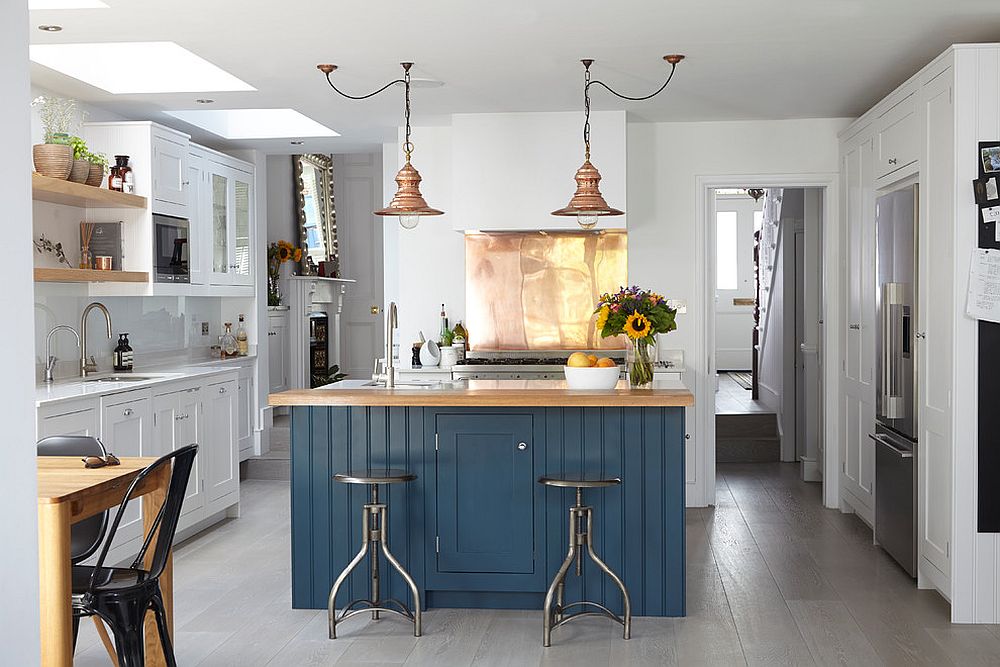 Modern industrial kitchen with a shiny copper backsplash