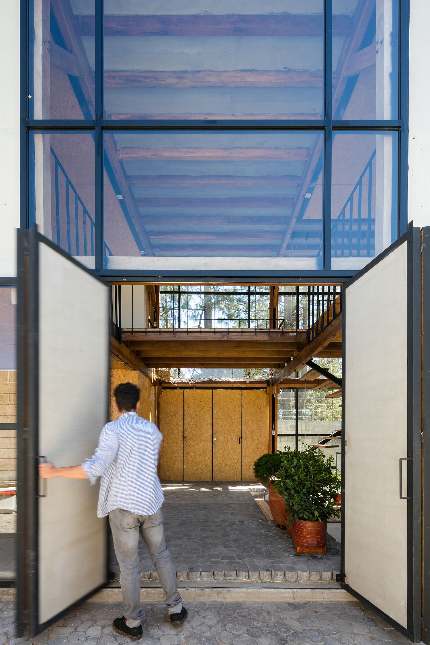 Open living area on the lower level offers unabated view of the rear garden even from the entrance