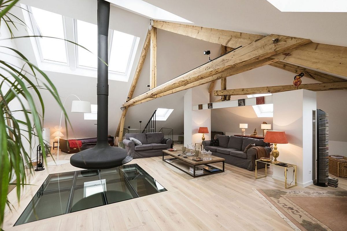 Revamped loft living space of the home in Luxembourg with a glass slab that fliters light to lowerr level