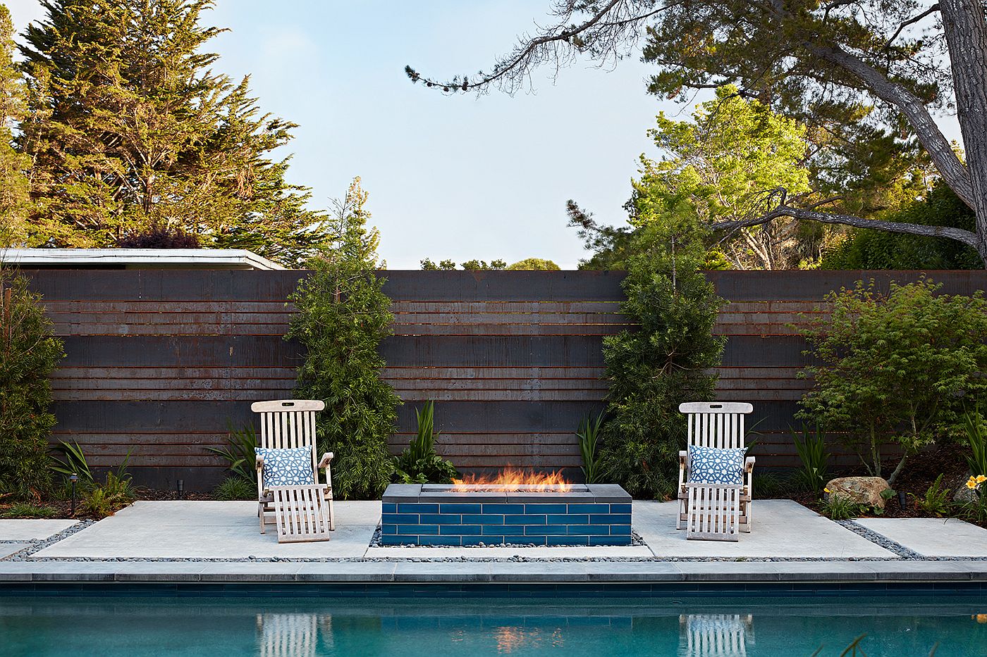 Simple hangout next to the pool with a modern fireplace