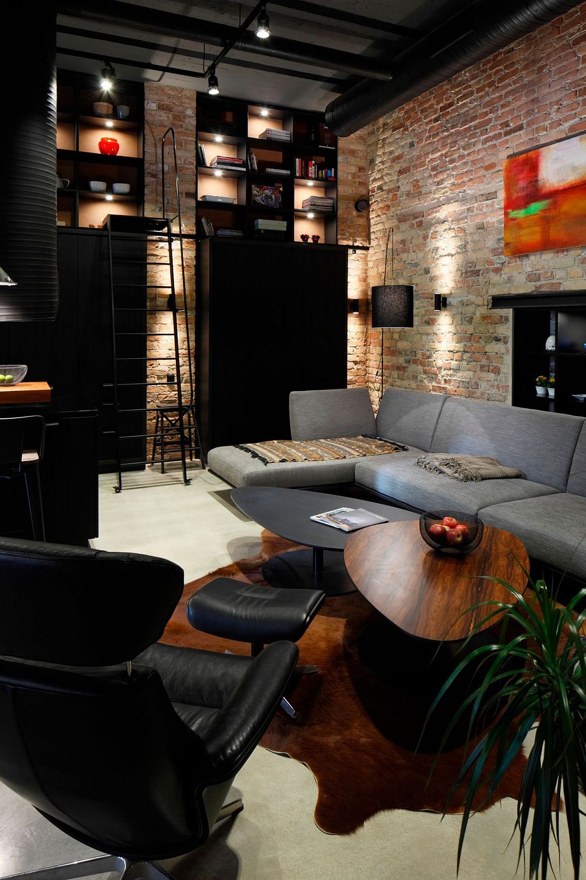 Smart shelving, open duct pipes and brick walls for the modern industrial living room