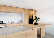 Spacious-kitchen-island-and-breakfast-zone-in-stone-and-oak-217x155