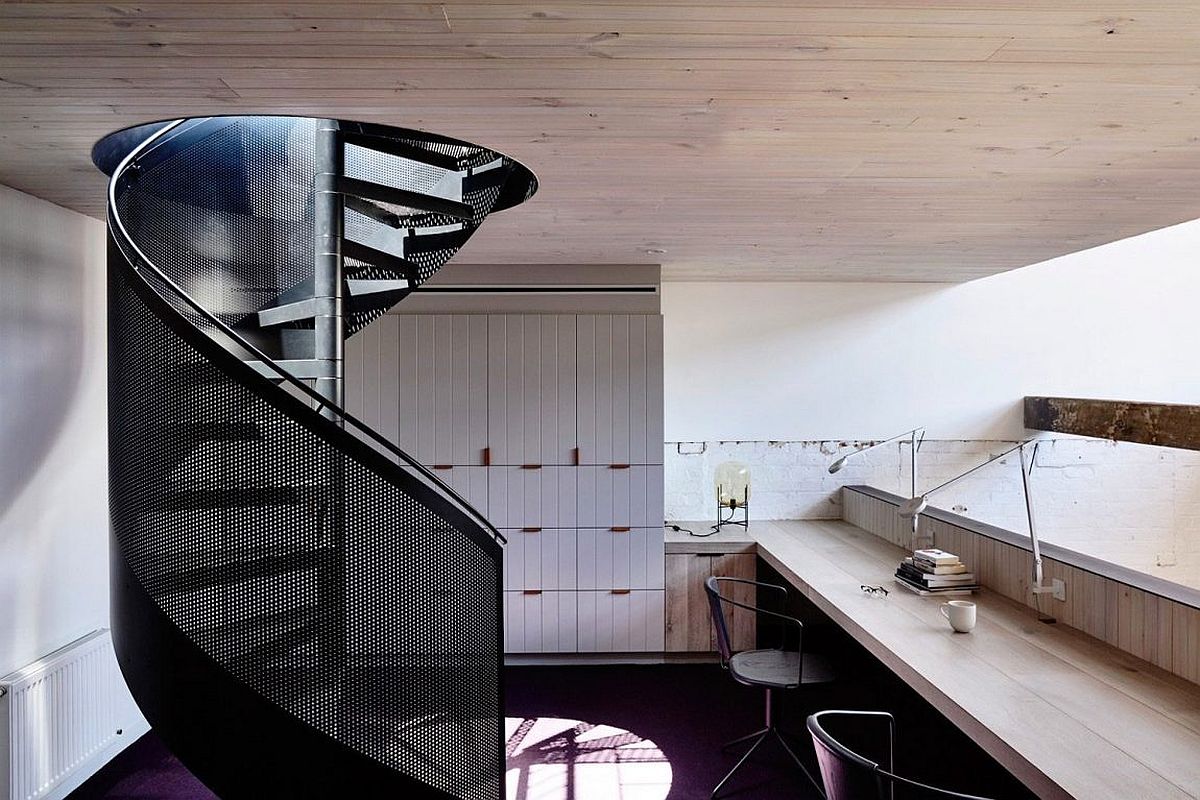 Spiral metal staircase leading to the private home office