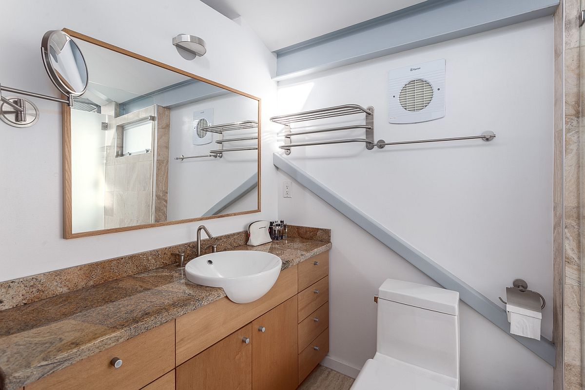 Stone and wood vanity inside the modern duplex loft