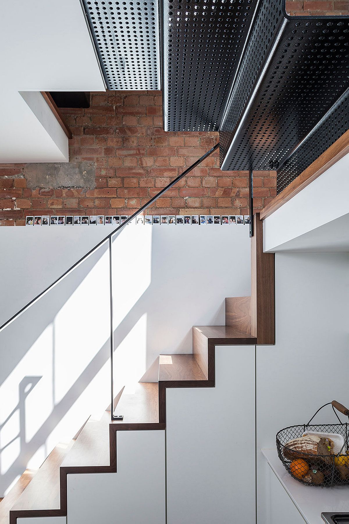 Storage space under the stairs along with perforated top level stairs that bring in natural light