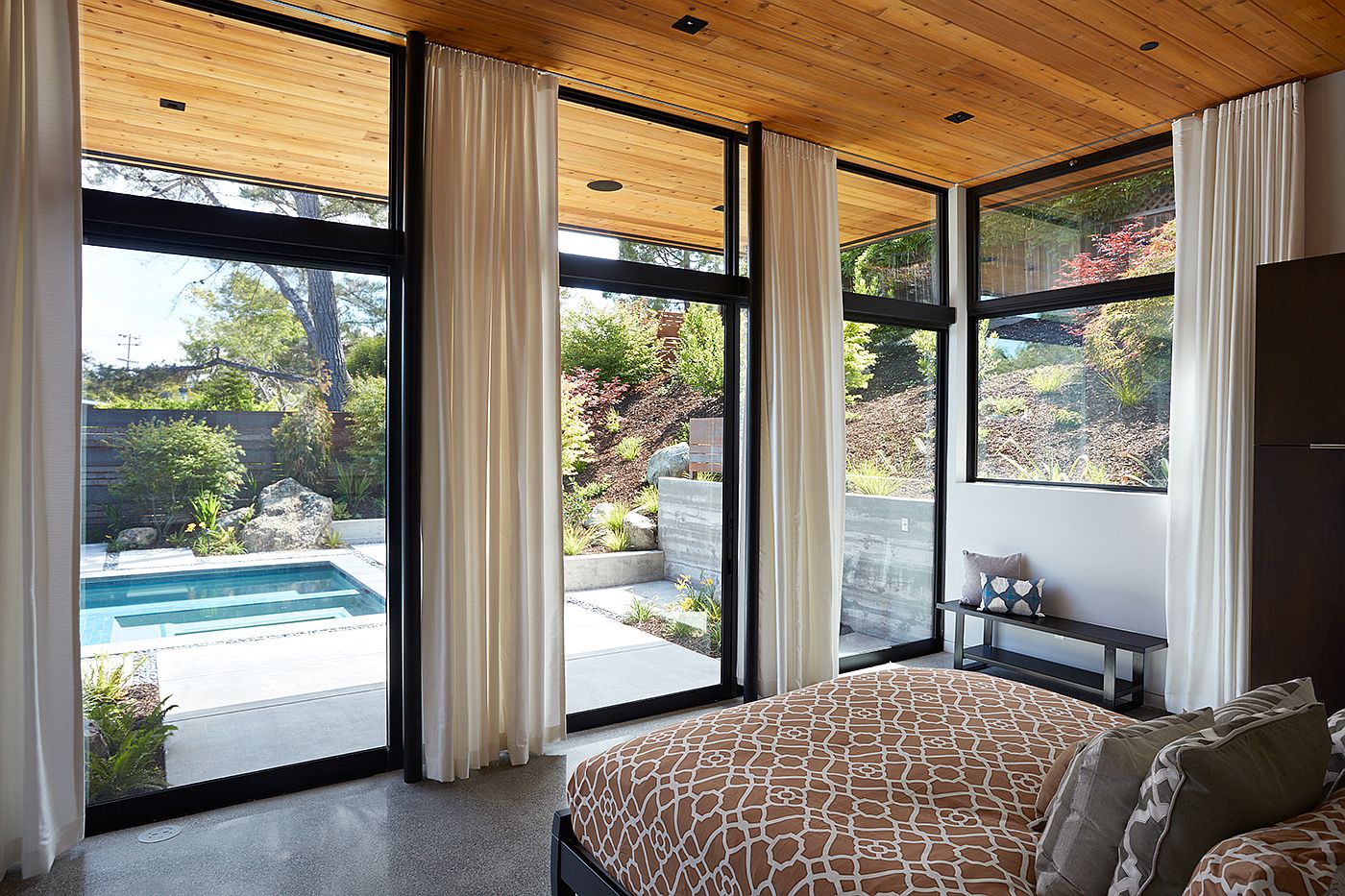 Tall drapes allow the homeowners to switch between privacy and pool view