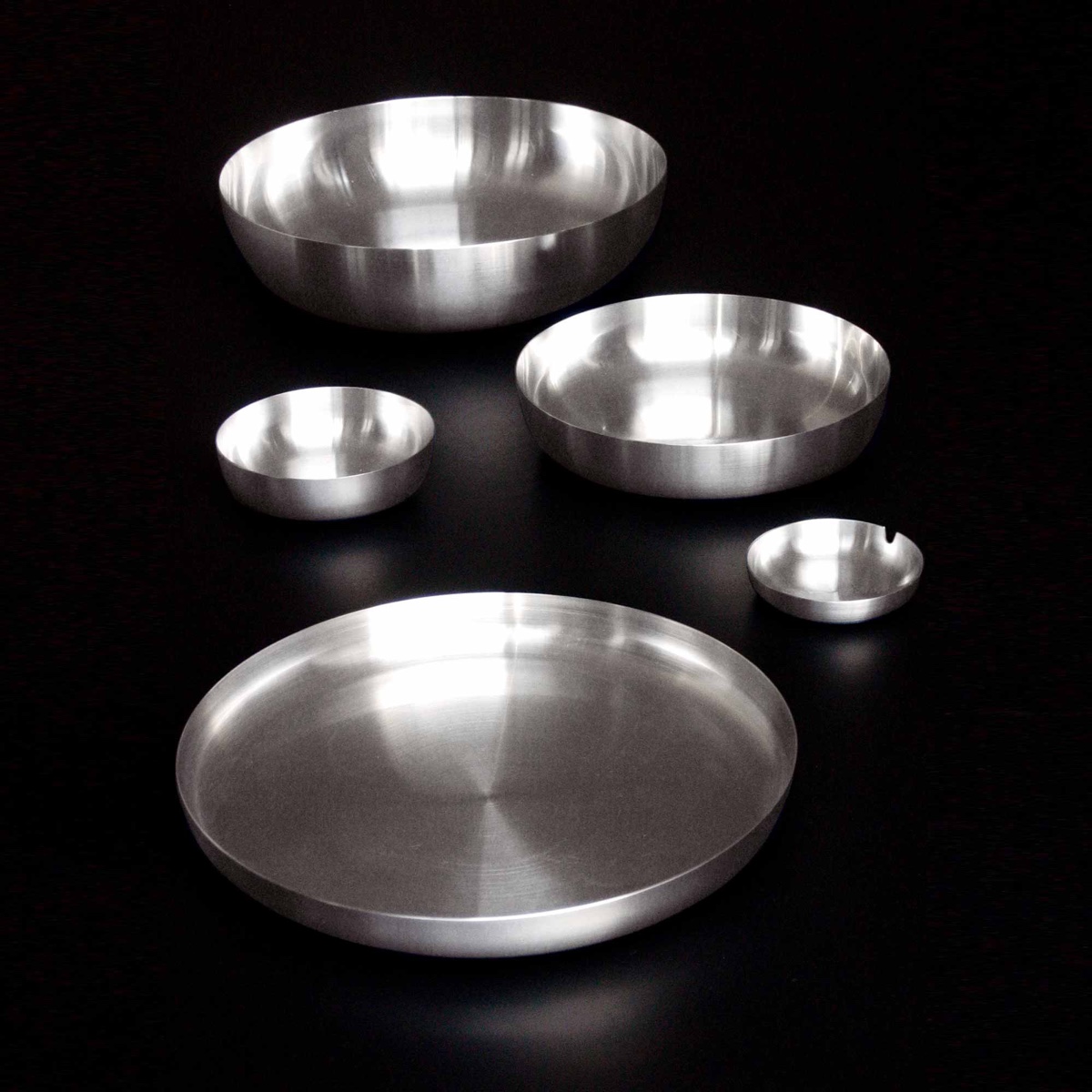 Tray Family (2001). A range of spun stainless-steel trays, bowls and an ashtray, designed for Alessi.