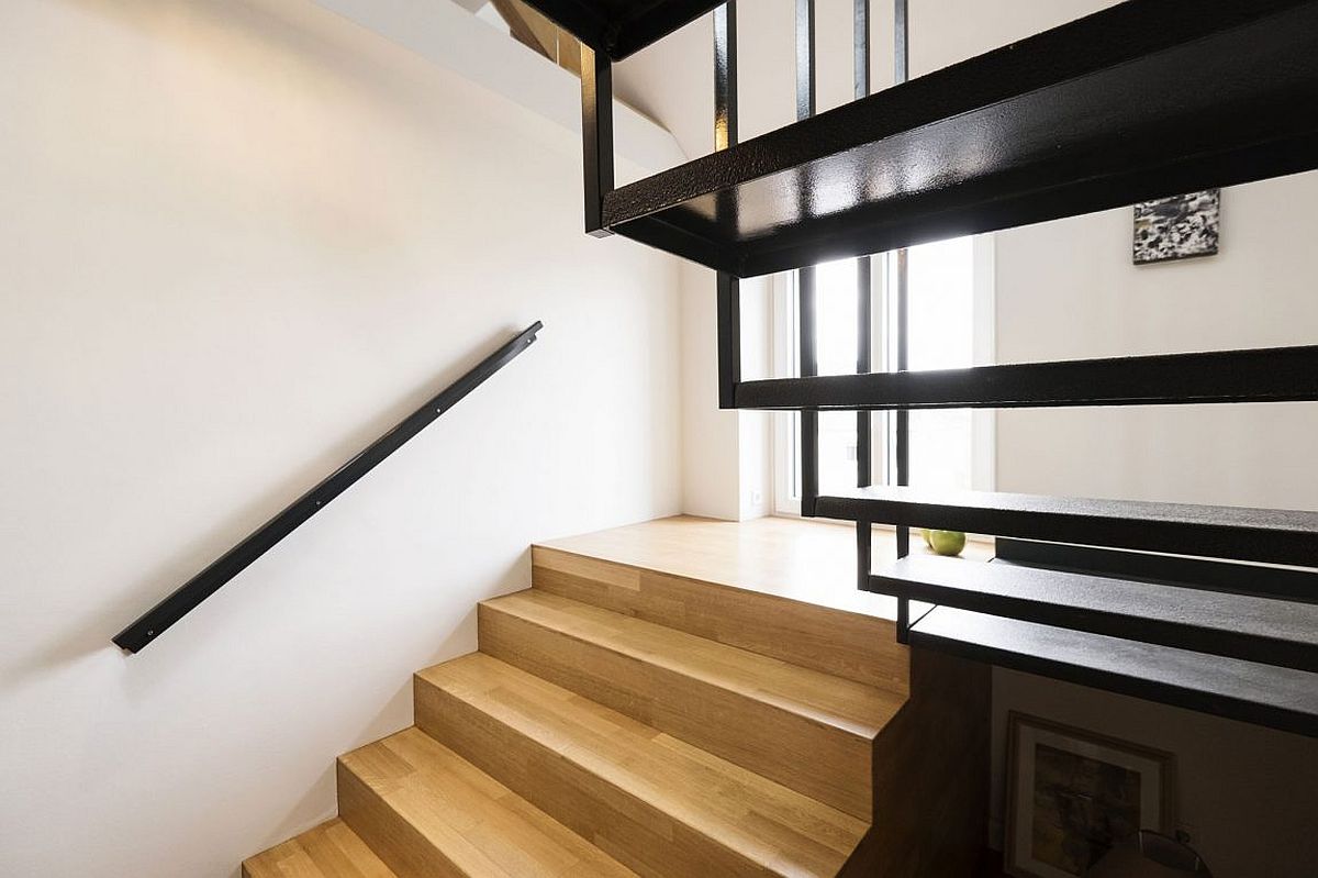 Wood and steel staircase connects the various levels of the house