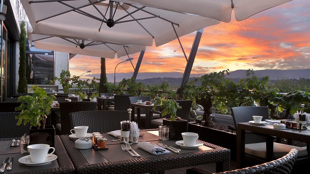 Breakfast with a view of sunrise above Geneva at luxurious hotel