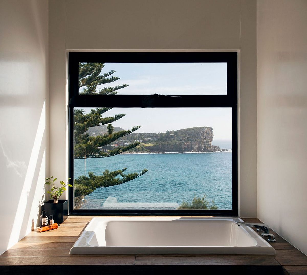 Enjoy an opulent dip in the bathroom with wooden deck, sunken bathtub and ocean view