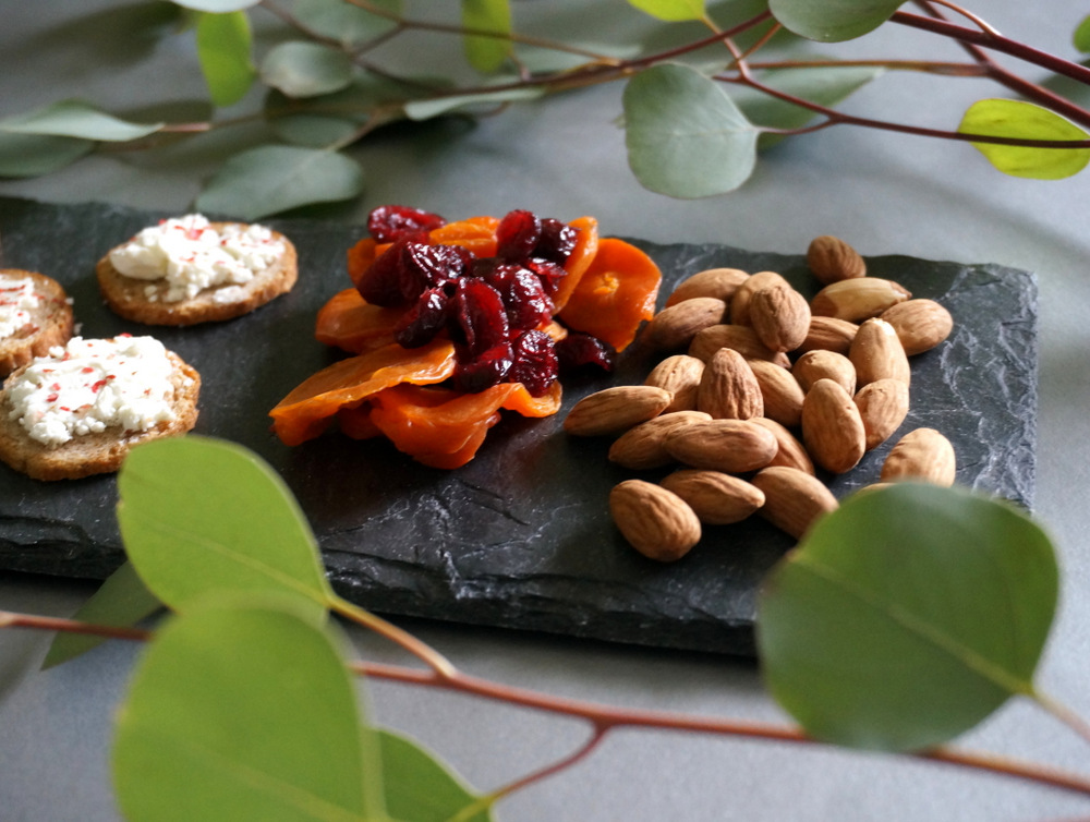 Eucalyptus leaves surround a cheese board