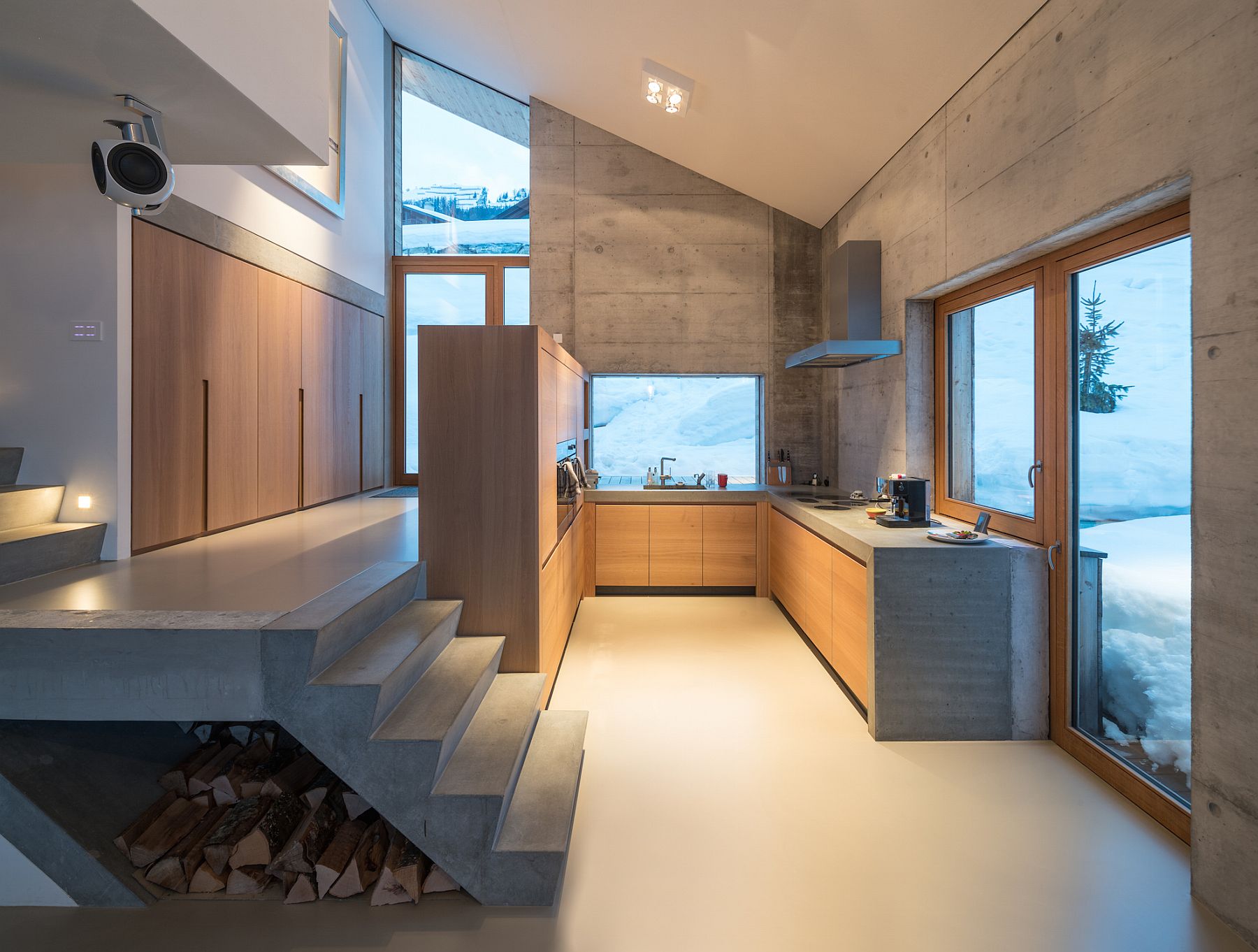 Exposed concrete and wood shape the interior of the contemporary Swiss chalet