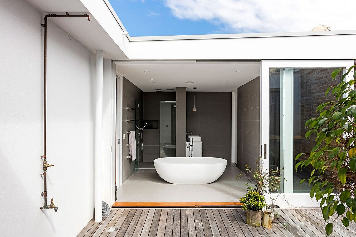 Fabulous bathroom in gray open to the private deck outside