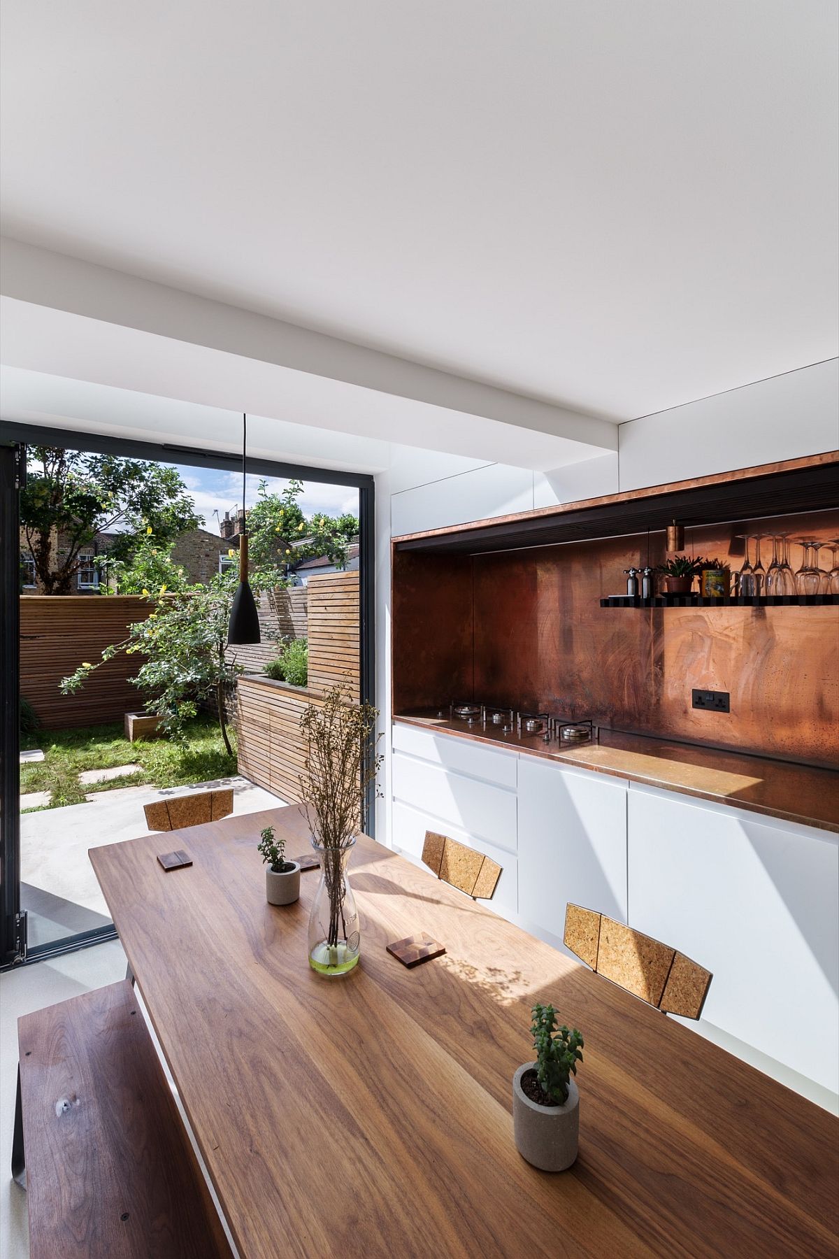 Fabulous kitchen in white with copper backsplash and dining area