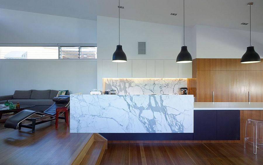 Marble kitchen island complements the marble backsplash of the stylish space perfectly [Design: Tim Stewart Architects]