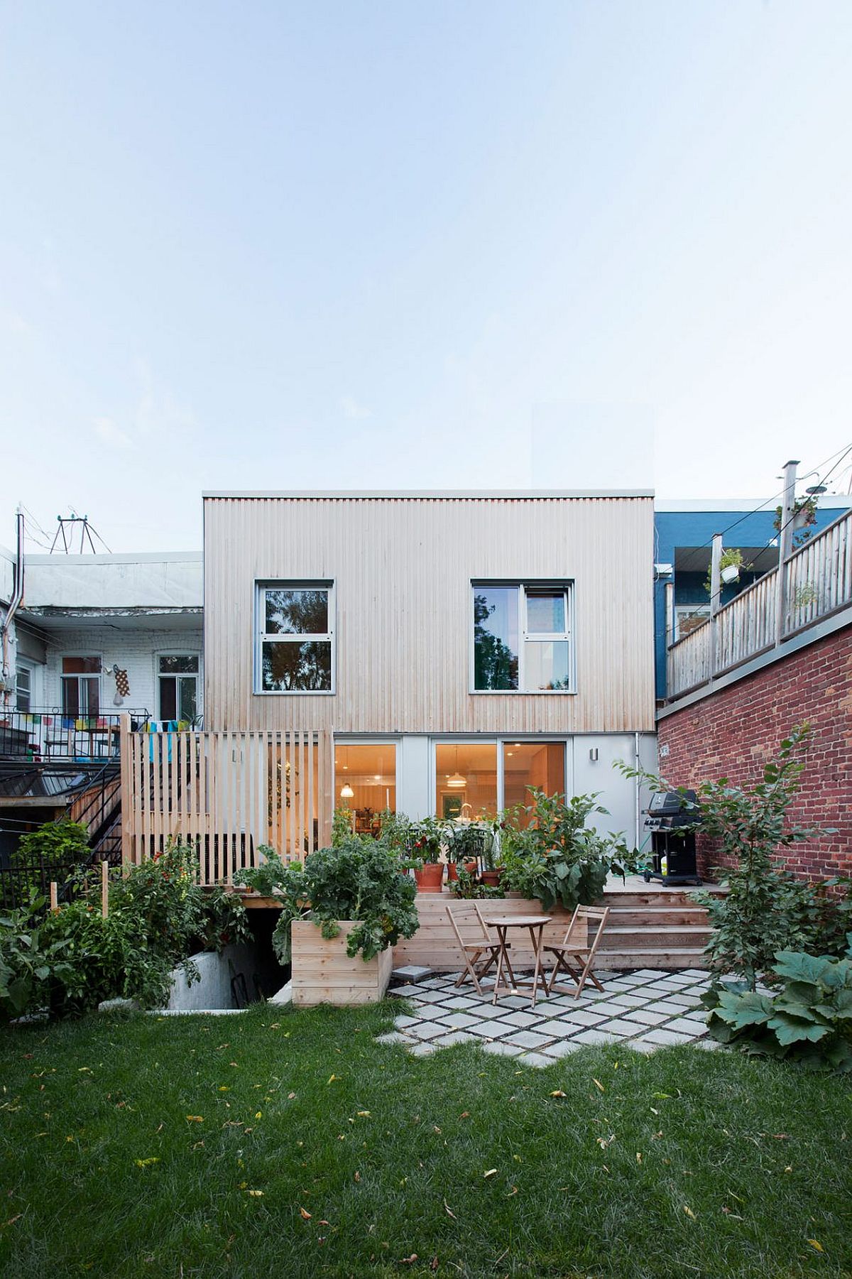 New wooden deck and outdoor living zone of the revamped home in Montreal