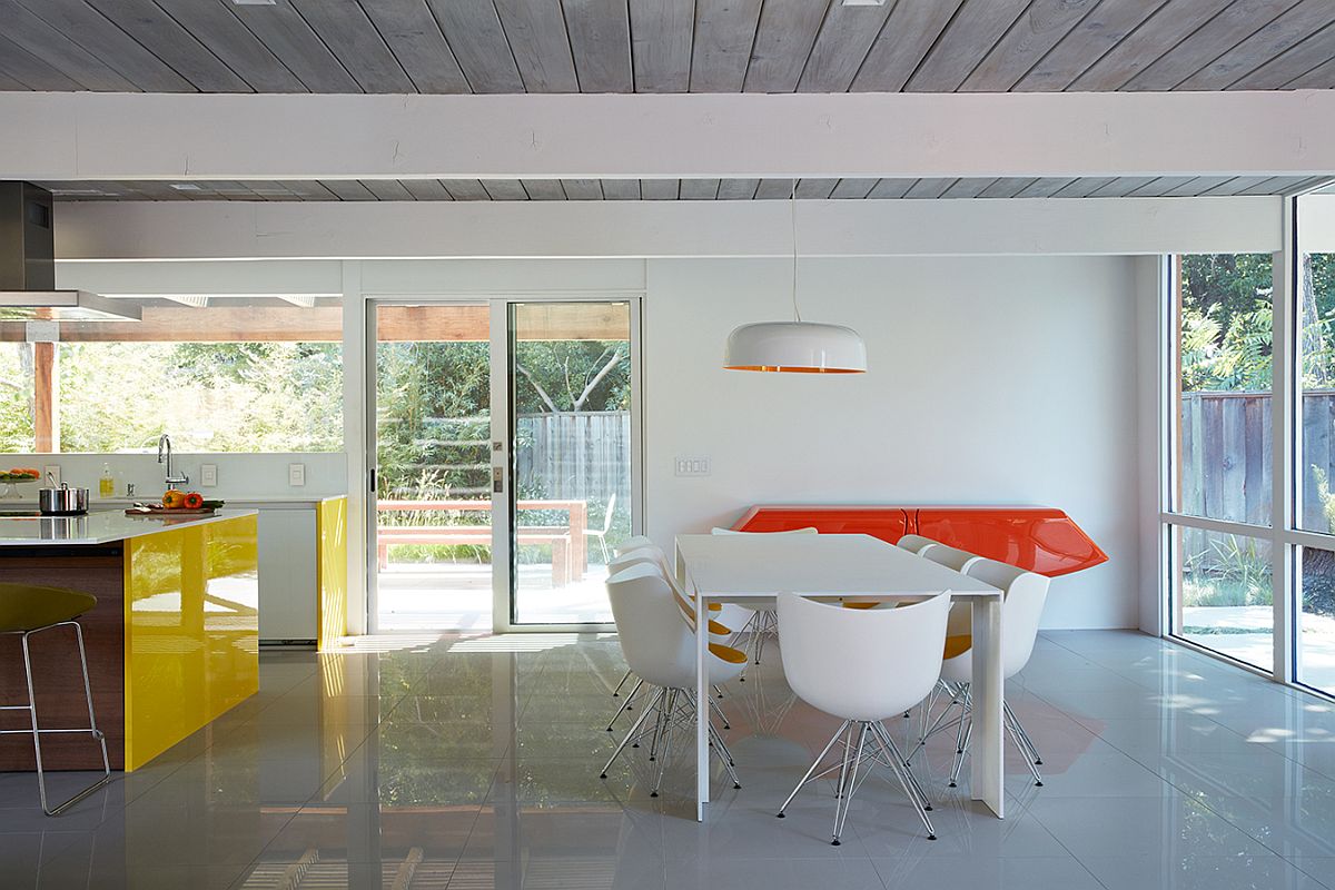 Orange adds zest and contrast to the neutral dining room