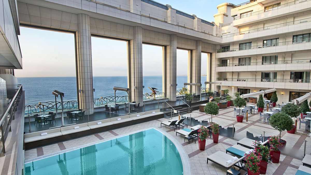 Outdoor swimming pool and lounge at Hyatt Regency Nice Palais de la Méditerranée overlooking the sea