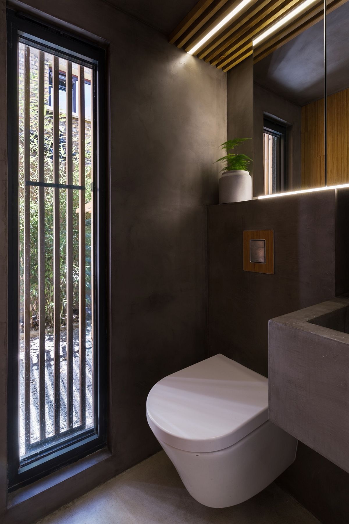 Polished concrete shapes the contemporary bathroom with garden view