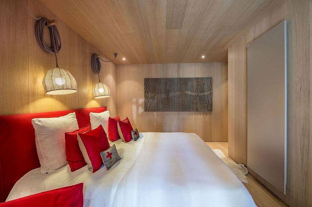 Pops of red enliven the chalet bedroom