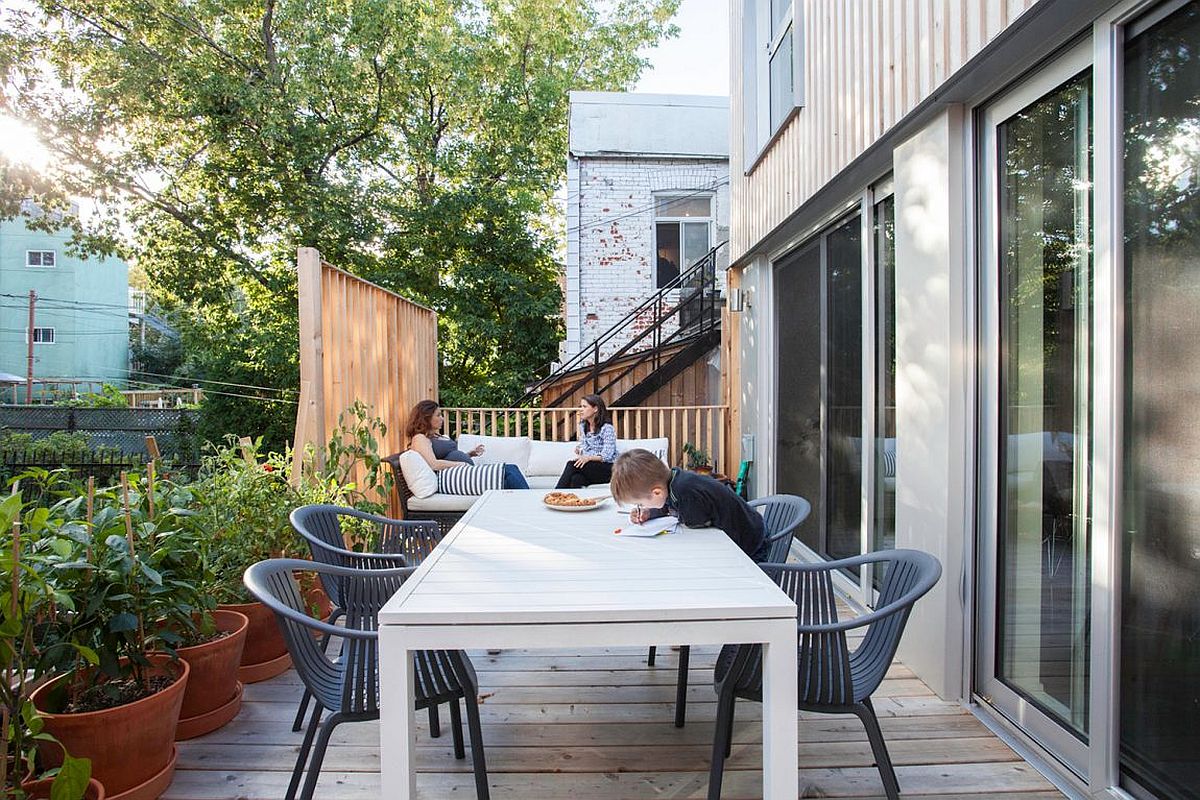 Small wooden deck with outdoor dining and a luxurious sofa