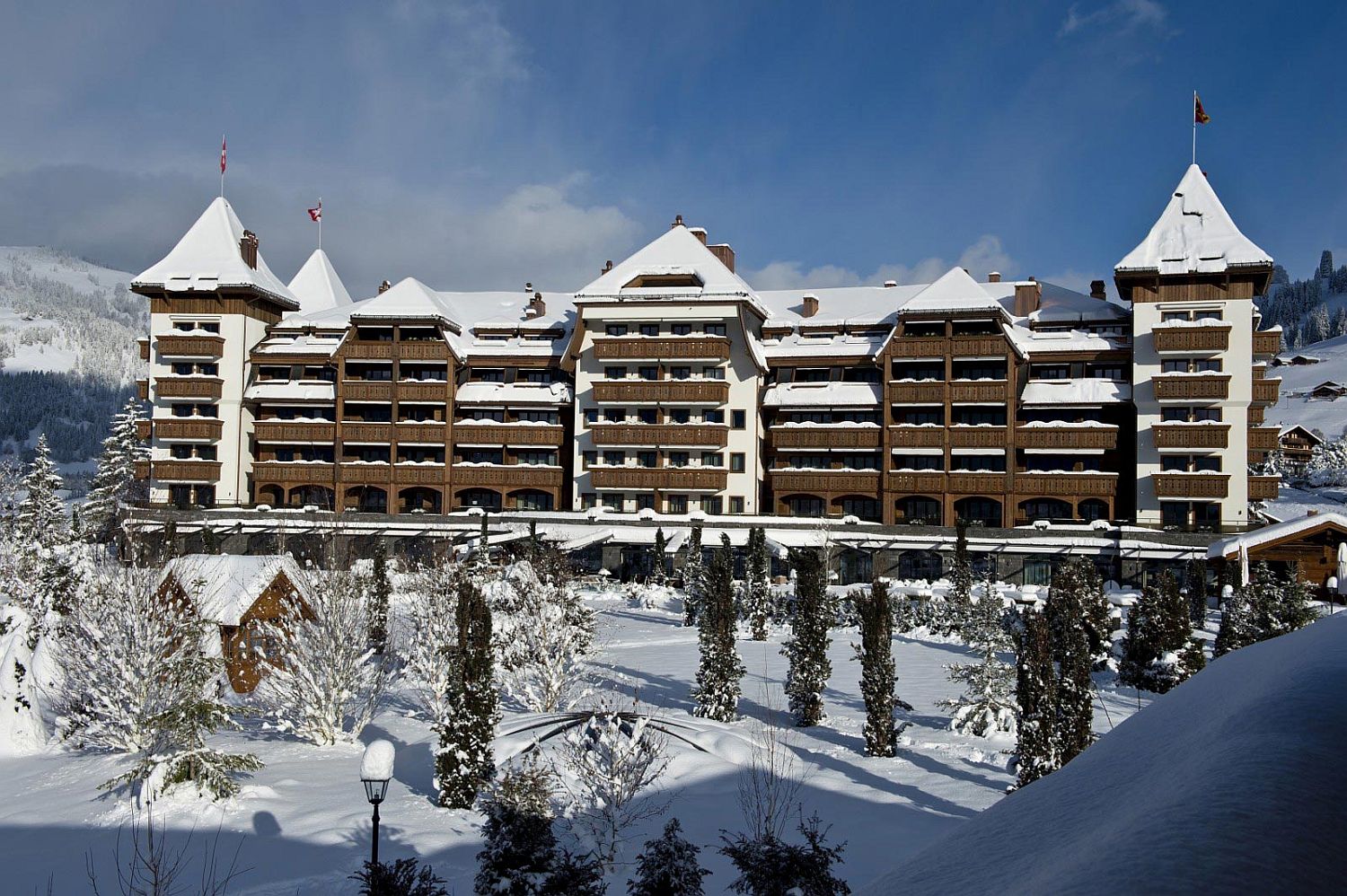 Snow-covered facade of luxurious 5-star hotel - Alpina Gstaad