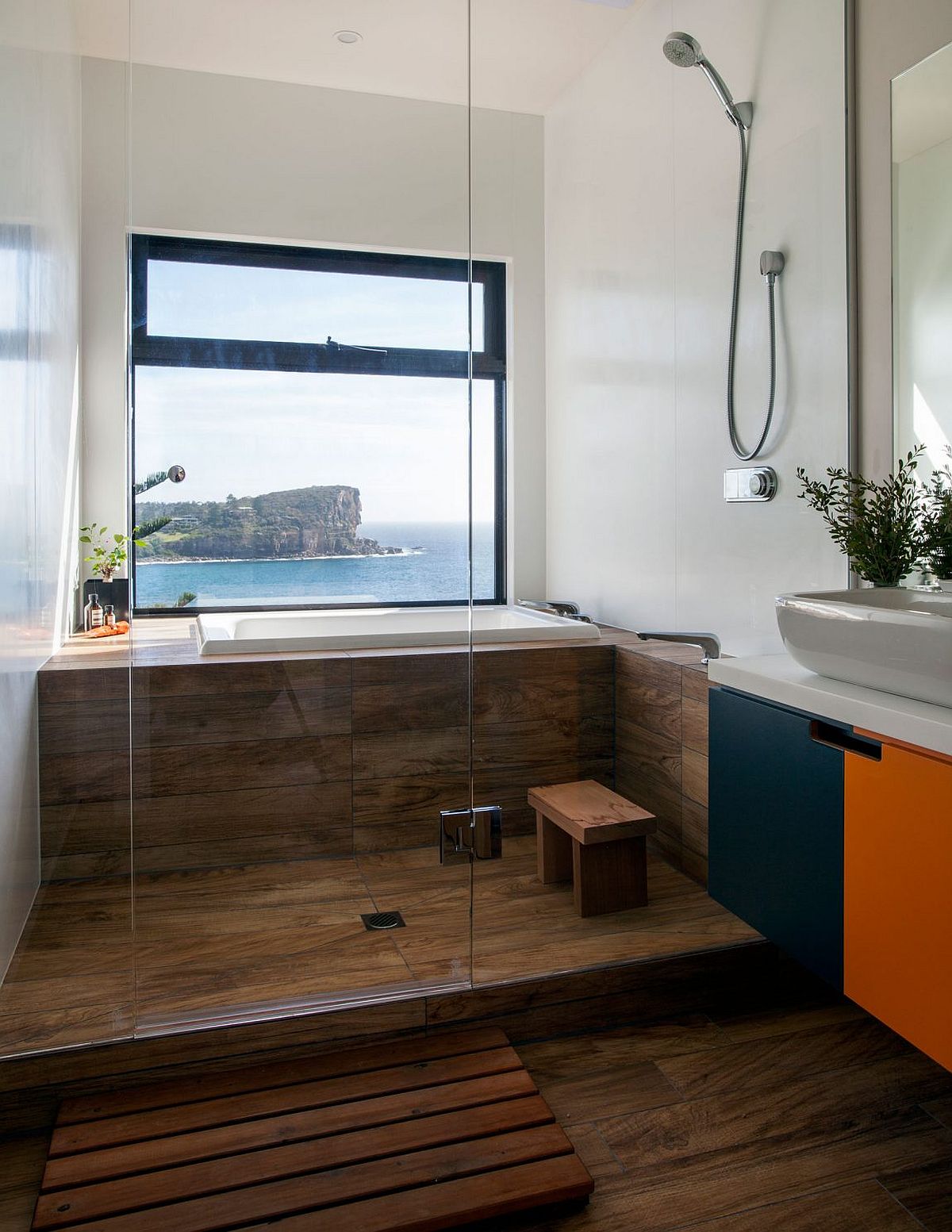 Stunning modern bathroom with a view of the ocean outside the window