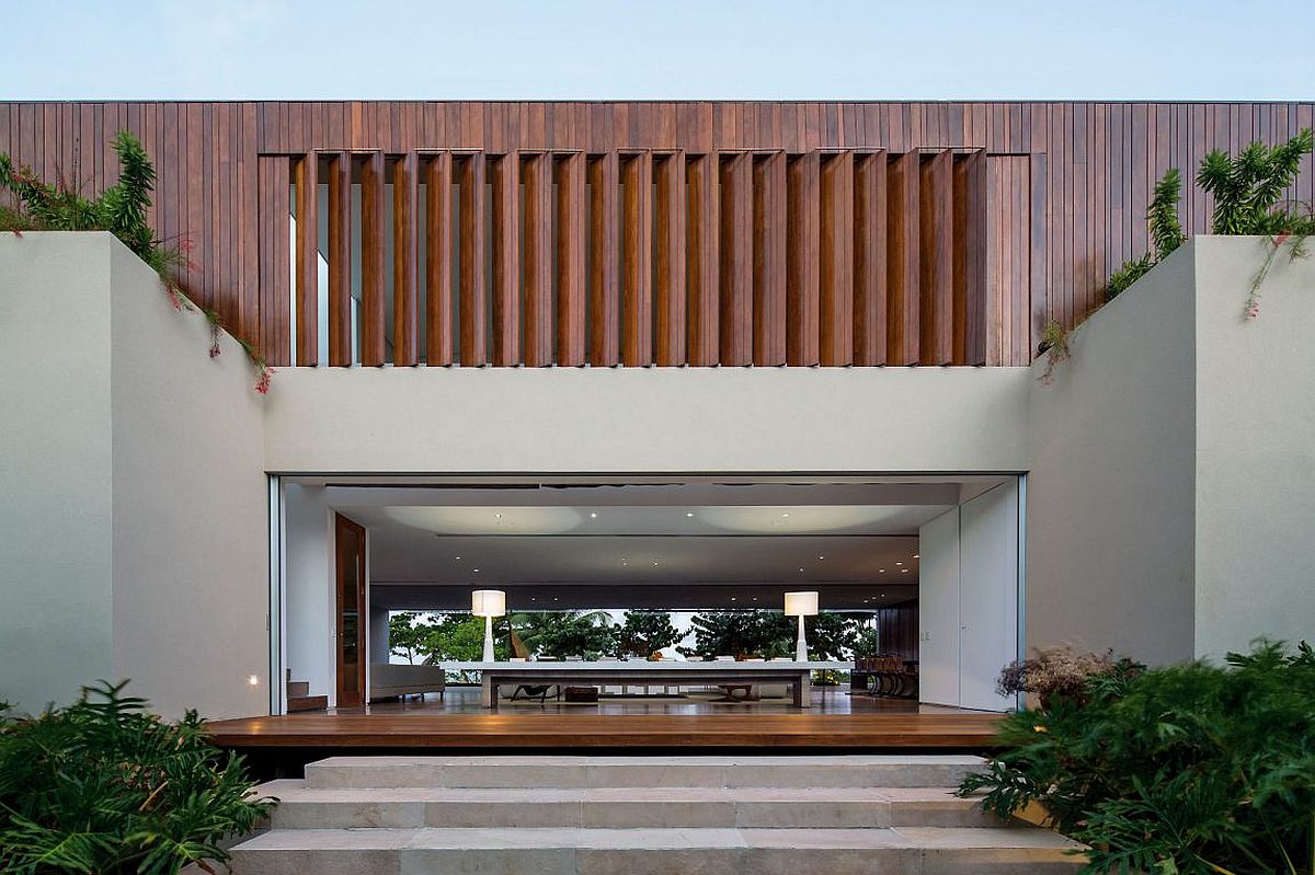 Wooden slats provide privacy and ventilation for the upper level of the contemporary home