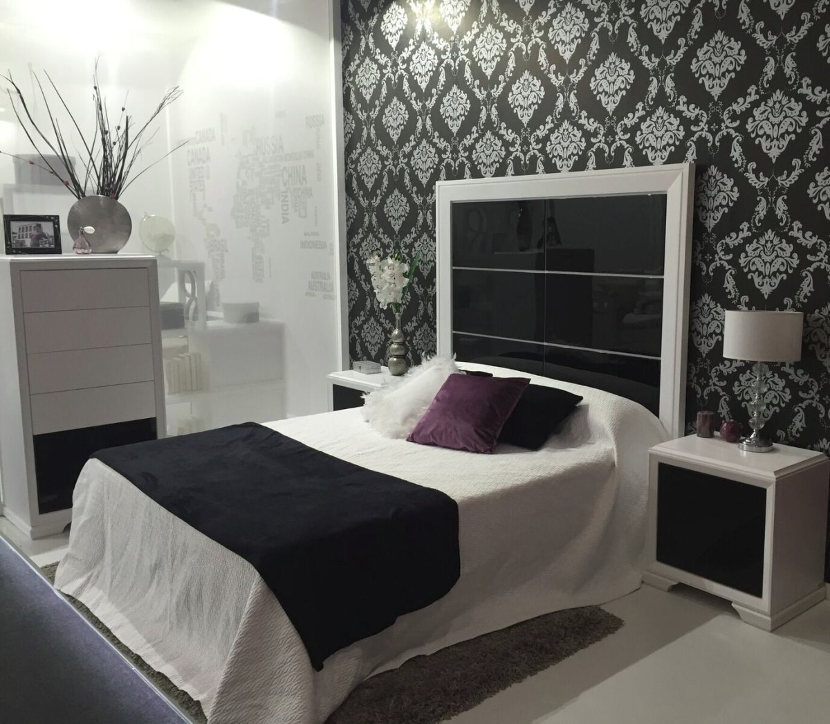 A wallpapered bedroom featuring furnishings by Lineasta