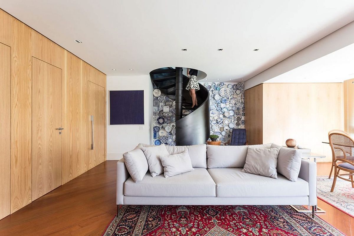 Blue plates create a stunning accent wall behind the spiral staircase