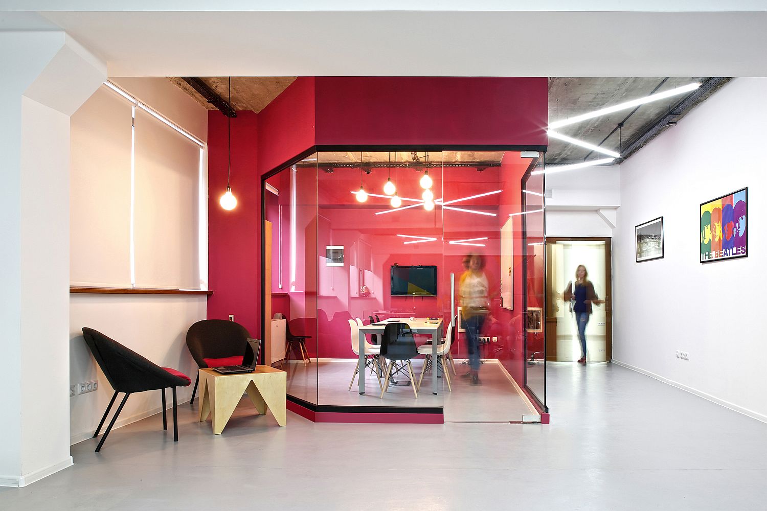 Bright and bold pink creates a vivacious conference room for the modern office