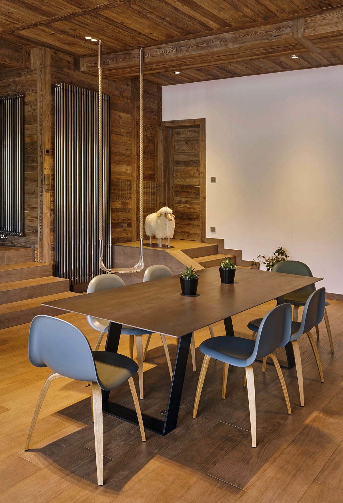 Ceiling clad in wood adds beauty to the dining room