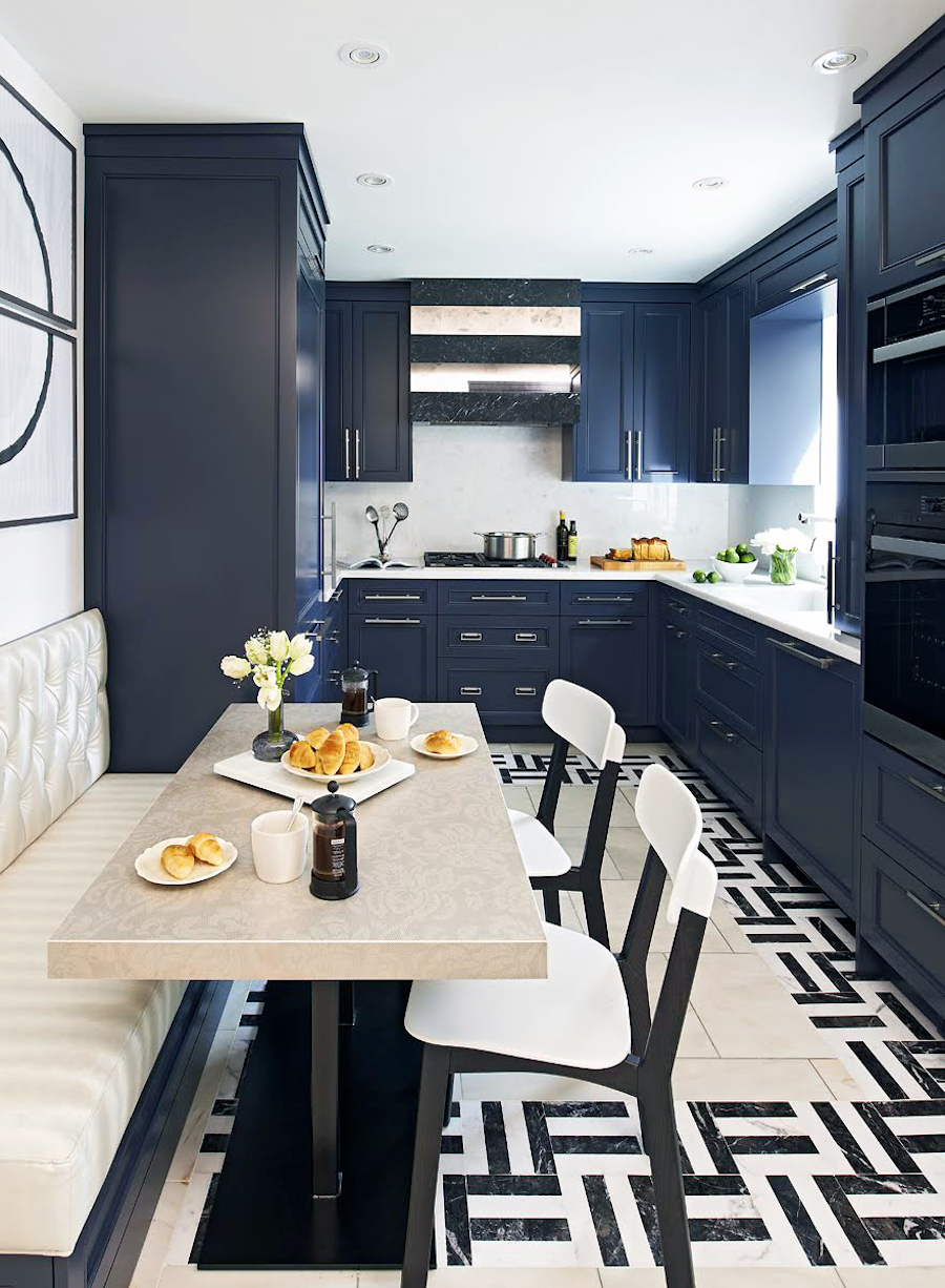 Cream colored banquette in a black and white kitchen