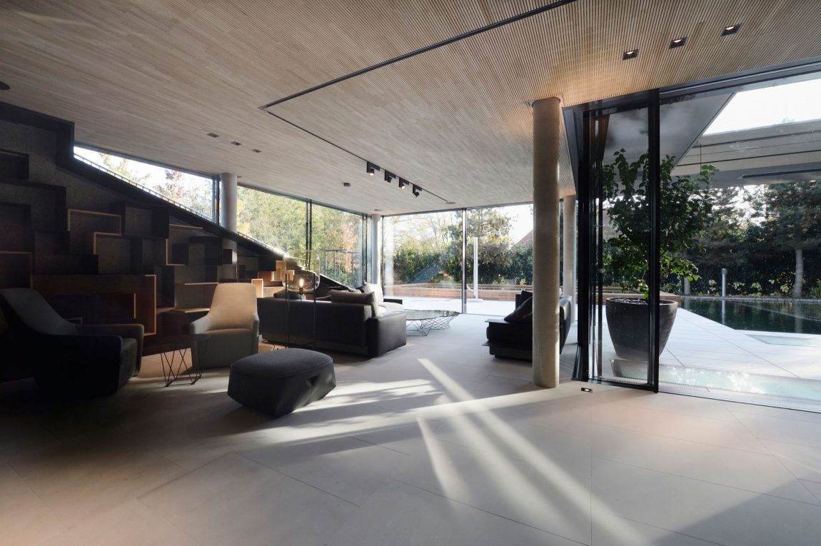 Dark backdrop of the staircase adds to the appeal of the living area