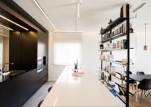 Dark-cabinets-and-bookshelf-flank-the-modern-kitchen-inside-the-penthouse-217x155