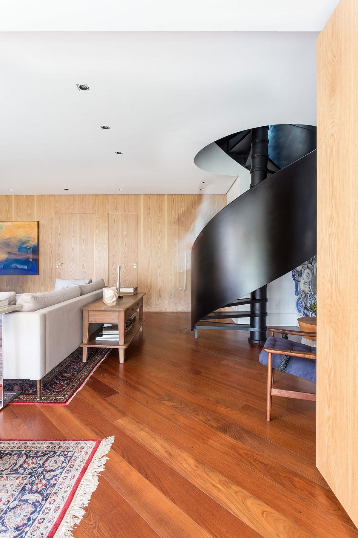 Dark spiral staircase becomes the showstopper of the modern Brazilian home