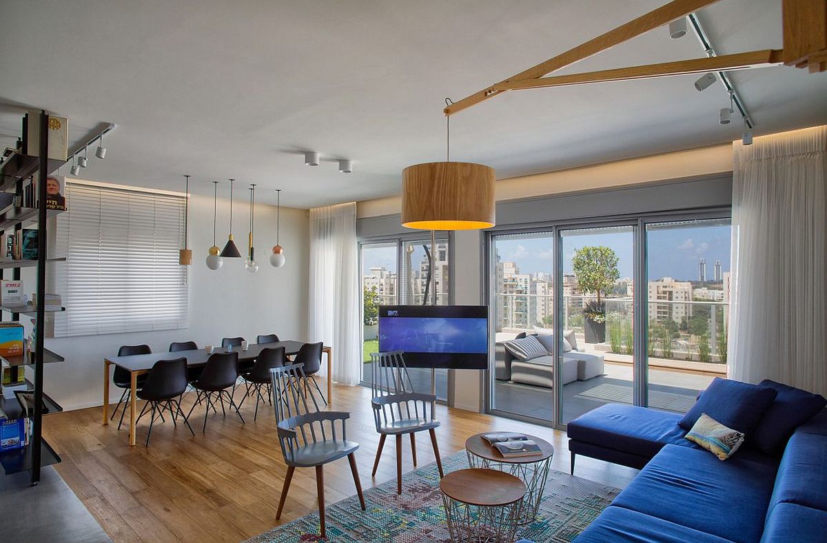 Dining area next to the living room with a swiveling TV at the heart of the space